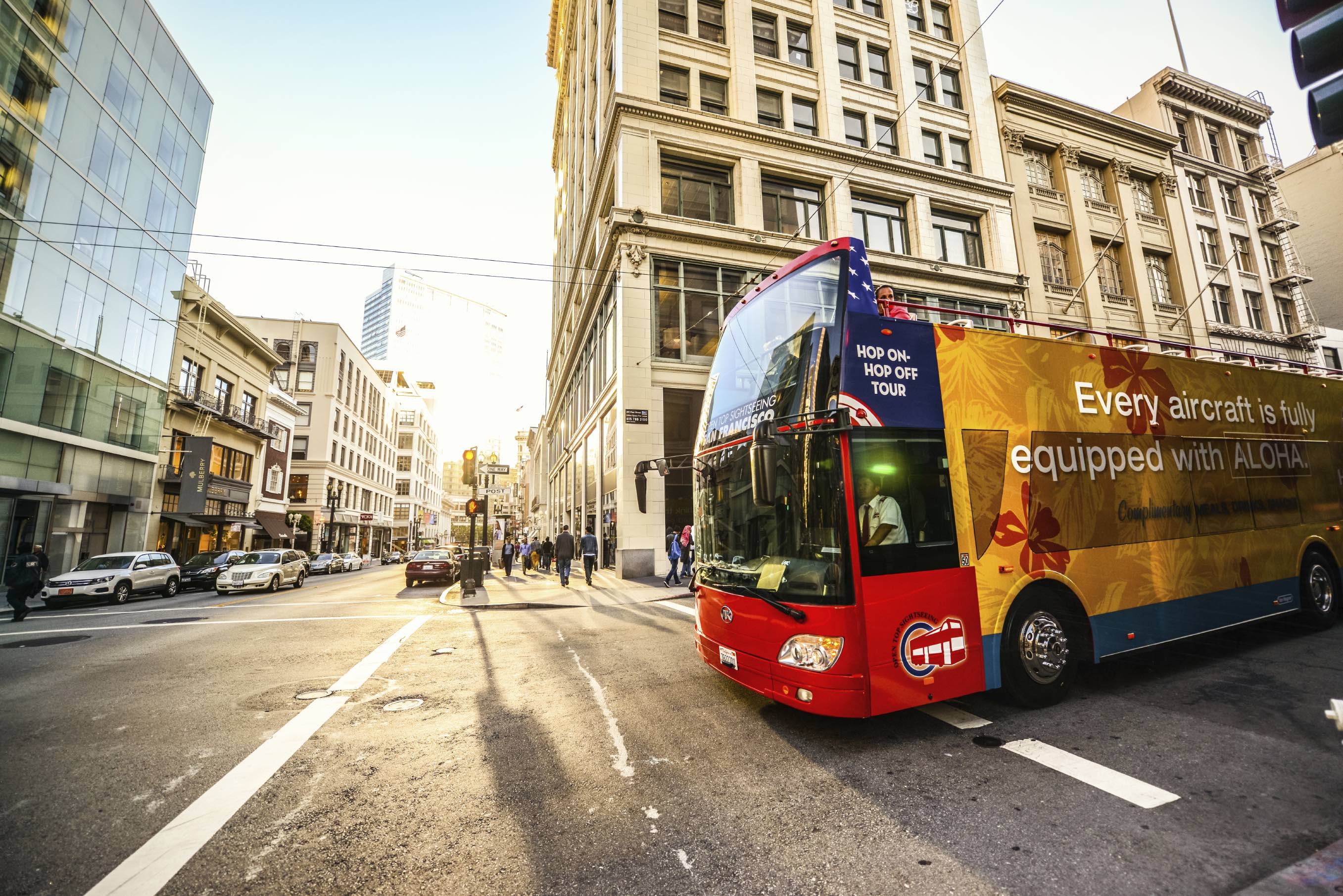Tour Bus moving on San Francisco street in the evening